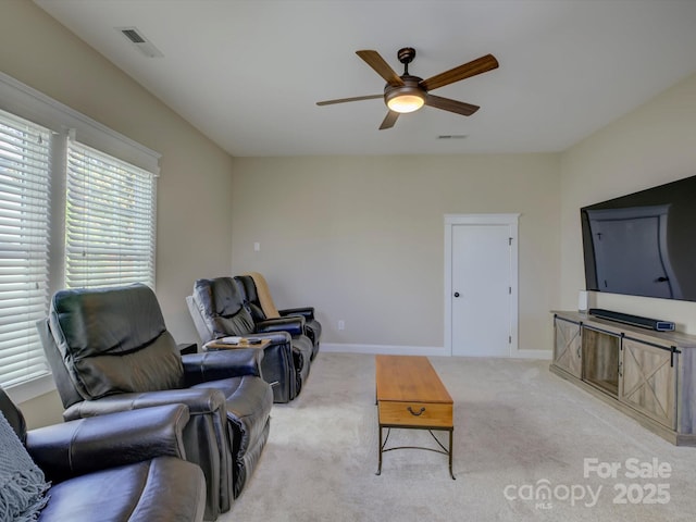 living room with light colored carpet and ceiling fan