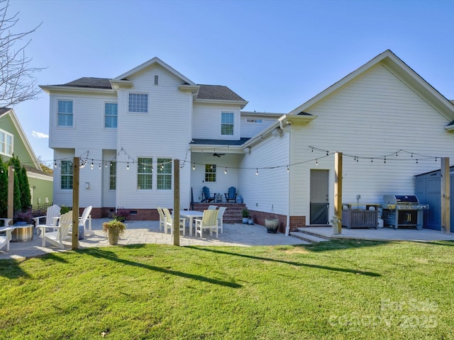 rear view of property with a yard, a patio area, and ceiling fan