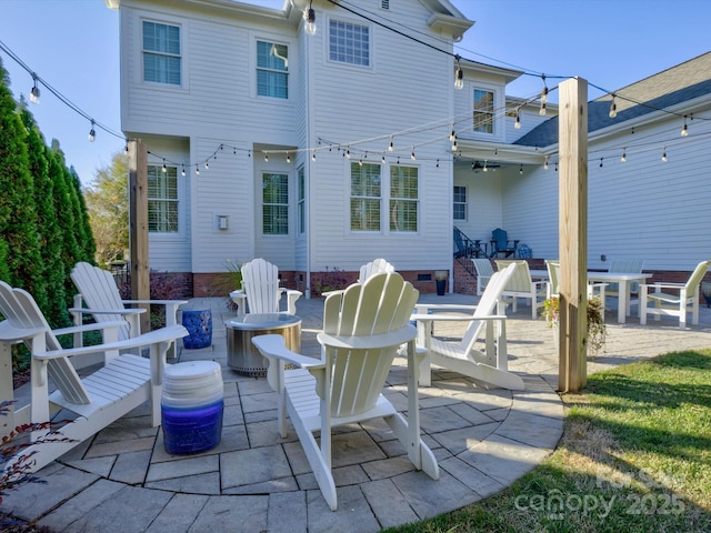 rear view of house with ceiling fan and a patio