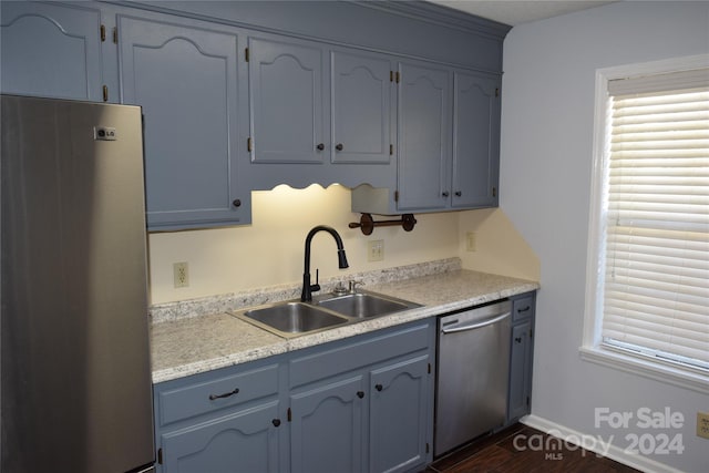 kitchen featuring dishwasher, dark hardwood / wood-style floors, sink, and fridge