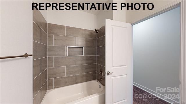 bathroom featuring hardwood / wood-style floors and tiled shower / bath