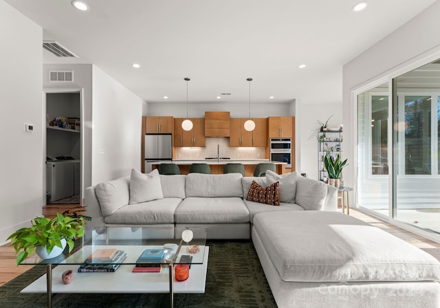 living room with dark hardwood / wood-style floors and sink