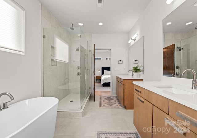 bathroom with vanity and independent shower and bath