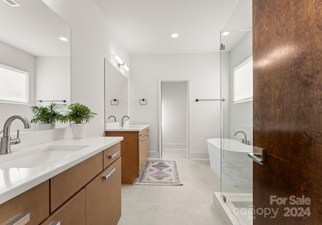 bathroom featuring tile patterned flooring, plenty of natural light, independent shower and bath, and vanity