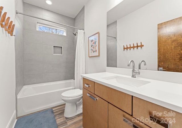 full bathroom with vanity, toilet, shower / bath combo with shower curtain, and wood-type flooring