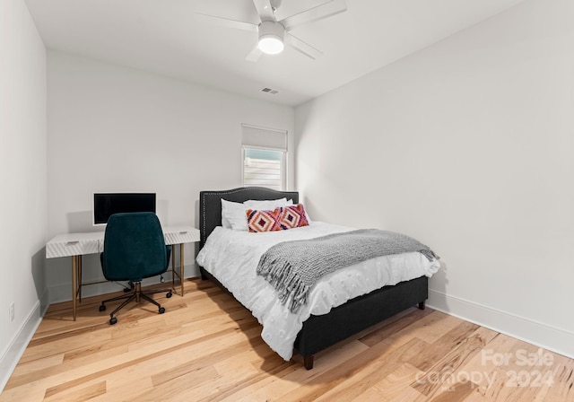 bedroom with ceiling fan and hardwood / wood-style floors