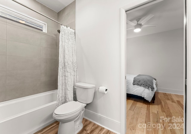 bathroom featuring ceiling fan, toilet, shower / tub combo with curtain, and hardwood / wood-style flooring