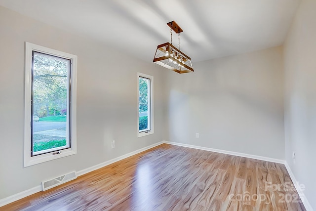 unfurnished room with light hardwood / wood-style floors