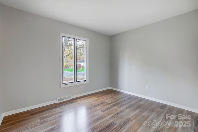 unfurnished room featuring light hardwood / wood-style floors