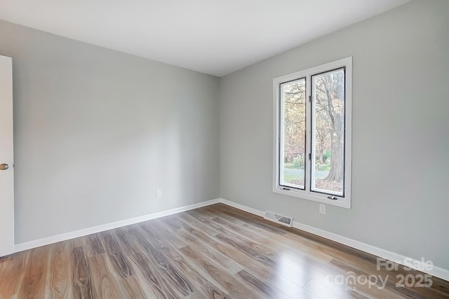 empty room with light hardwood / wood-style flooring