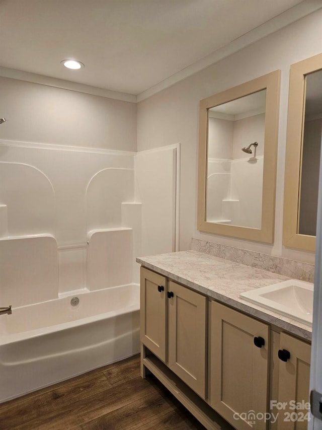 bathroom featuring hardwood / wood-style floors, vanity, and bathtub / shower combination