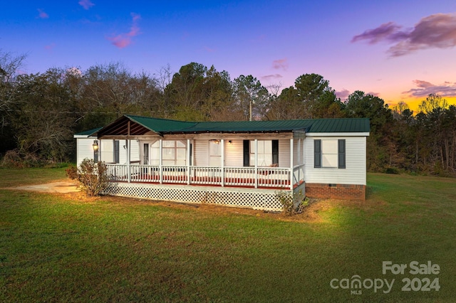 view of front of home with a lawn and covered porch