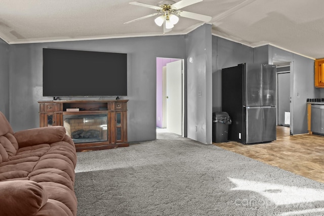 carpeted living room featuring a textured ceiling, ceiling fan, crown molding, and lofted ceiling