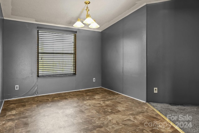 empty room featuring vaulted ceiling, ornamental molding, a textured ceiling, and an inviting chandelier