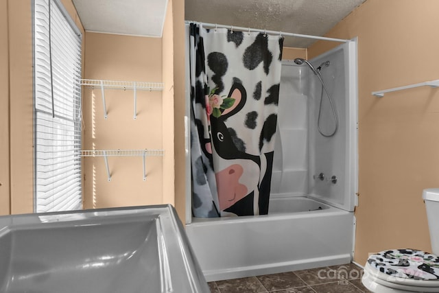 full bathroom with tile patterned floors, sink, toilet, shower / bath combo with shower curtain, and a textured ceiling