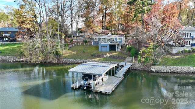 dock area with a yard and a water view