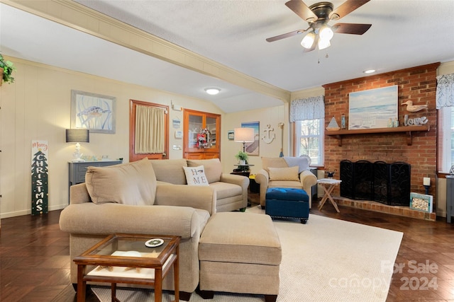 living room with a textured ceiling, ceiling fan, and a fireplace