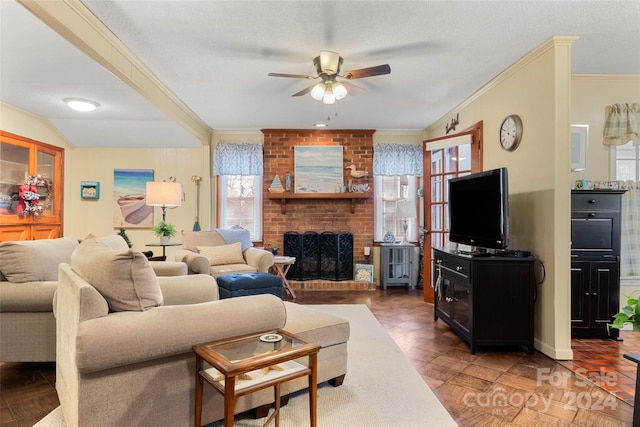 living room featuring ceiling fan, a healthy amount of sunlight, and a fireplace