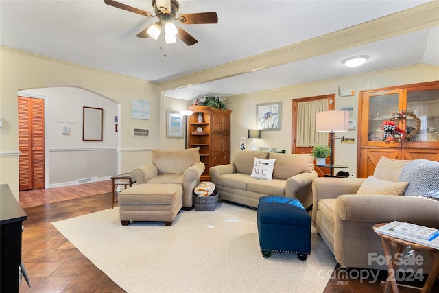 living room featuring ceiling fan and crown molding