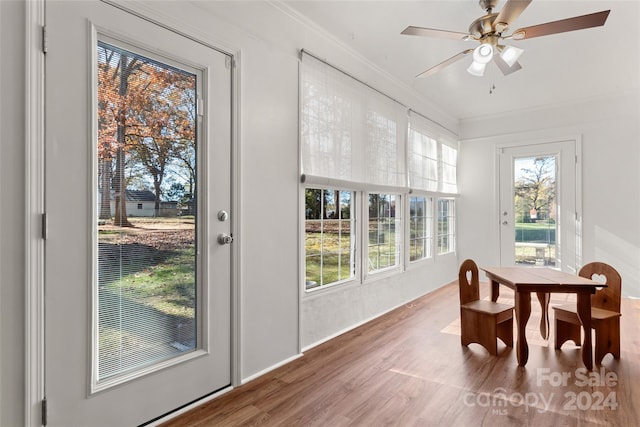 dining room featuring wood-type flooring, ceiling fan, and crown molding