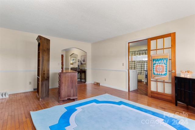 interior space featuring hardwood / wood-style floors and a textured ceiling