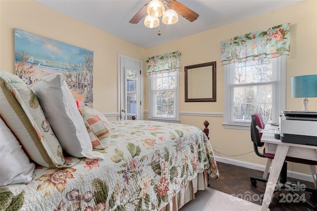 bedroom with dark tile patterned floors and ceiling fan