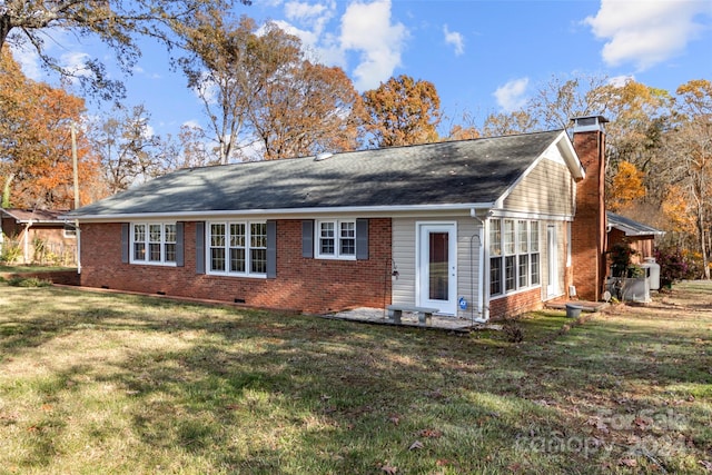 rear view of house featuring a lawn