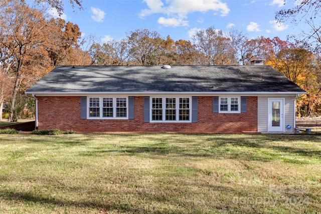 rear view of house with a yard