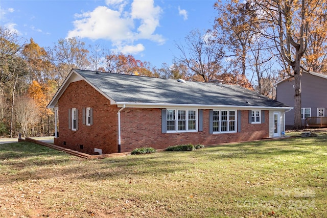 rear view of property featuring a lawn