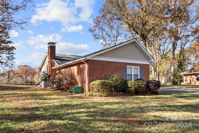 view of home's exterior with a lawn