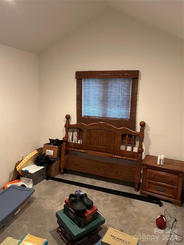 carpeted bedroom with vaulted ceiling