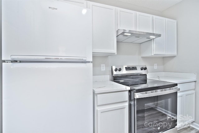 kitchen with white cabinetry, stainless steel electric range oven, and white fridge