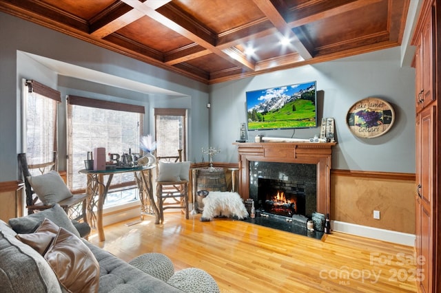 living room with crown molding, a high end fireplace, coffered ceiling, and hardwood / wood-style floors