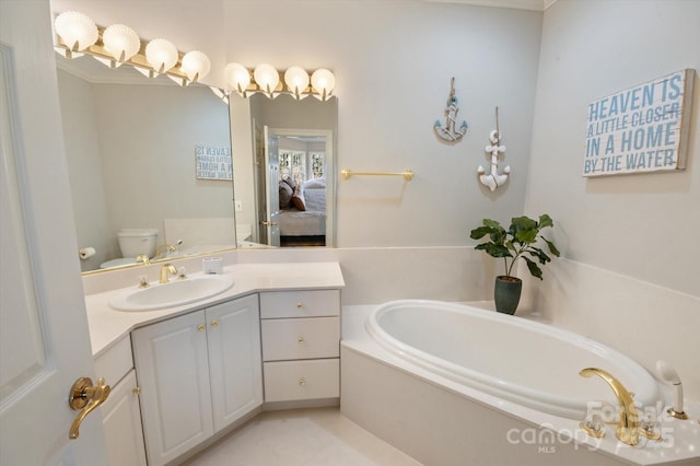 bathroom featuring vanity, a tub, and toilet