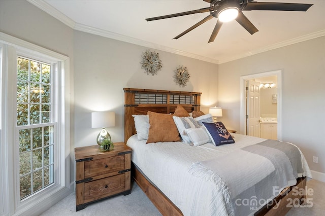 carpeted bedroom with connected bathroom, crown molding, and ceiling fan