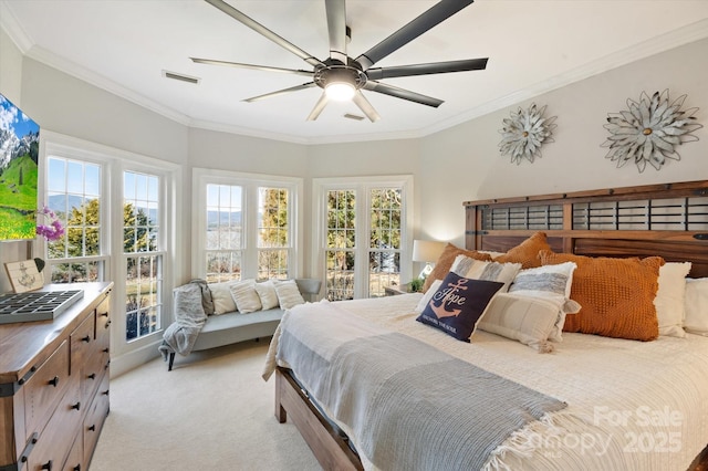 carpeted bedroom featuring ceiling fan and ornamental molding