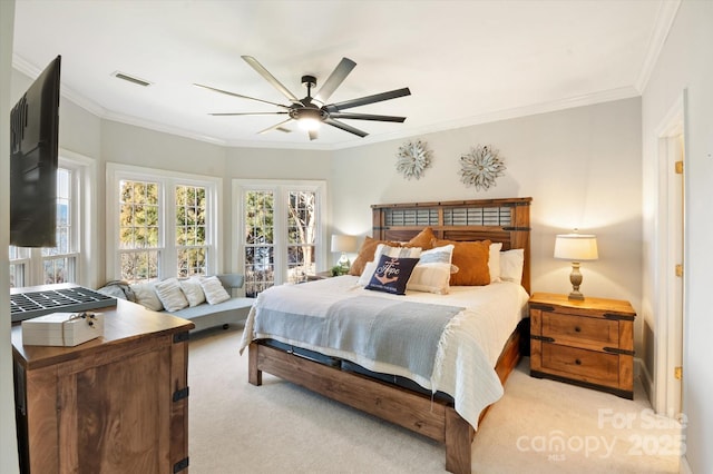 bedroom featuring crown molding, light carpet, and ceiling fan