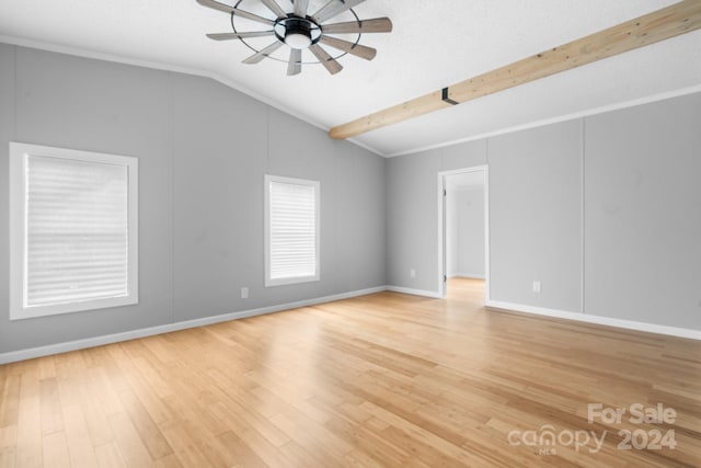 unfurnished room featuring lofted ceiling with beams, light hardwood / wood-style floors, and ceiling fan