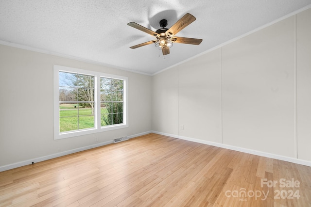 unfurnished room with ceiling fan, light hardwood / wood-style floors, a textured ceiling, and ornamental molding