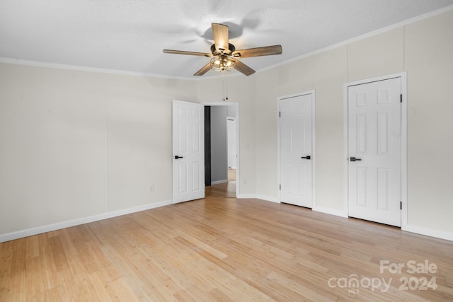 unfurnished bedroom featuring hardwood / wood-style flooring, ceiling fan, and ornamental molding