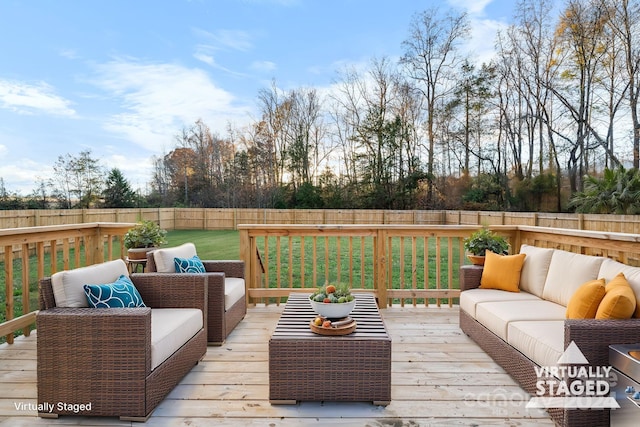 wooden deck featuring a yard and an outdoor living space