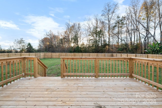 wooden deck with a lawn