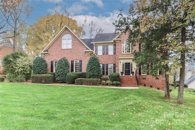 colonial home with a front lawn