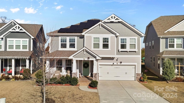 craftsman-style house with solar panels and a garage