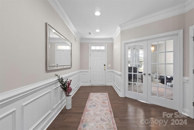 entryway featuring plenty of natural light, dark hardwood / wood-style flooring, ornamental molding, and french doors