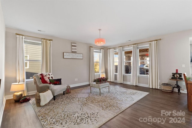 sitting room with a chandelier and wood-type flooring