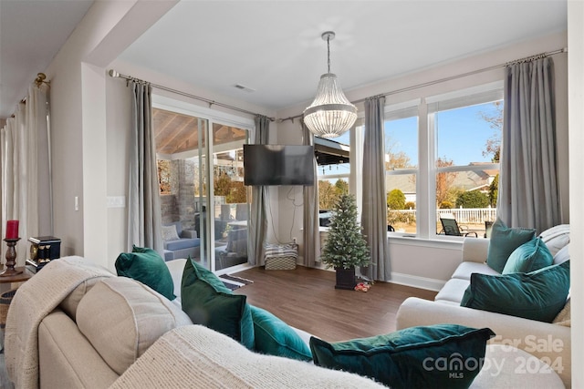 interior space with hardwood / wood-style floors and an inviting chandelier