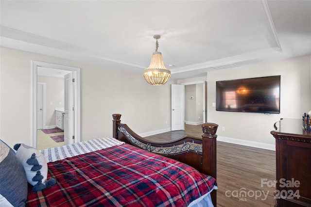 bedroom with a chandelier and dark hardwood / wood-style floors