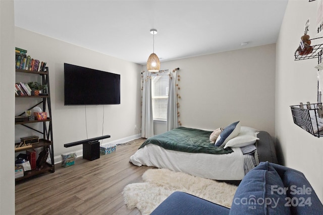 bedroom with hardwood / wood-style flooring