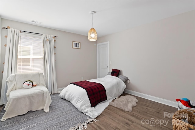 bedroom with dark hardwood / wood-style flooring